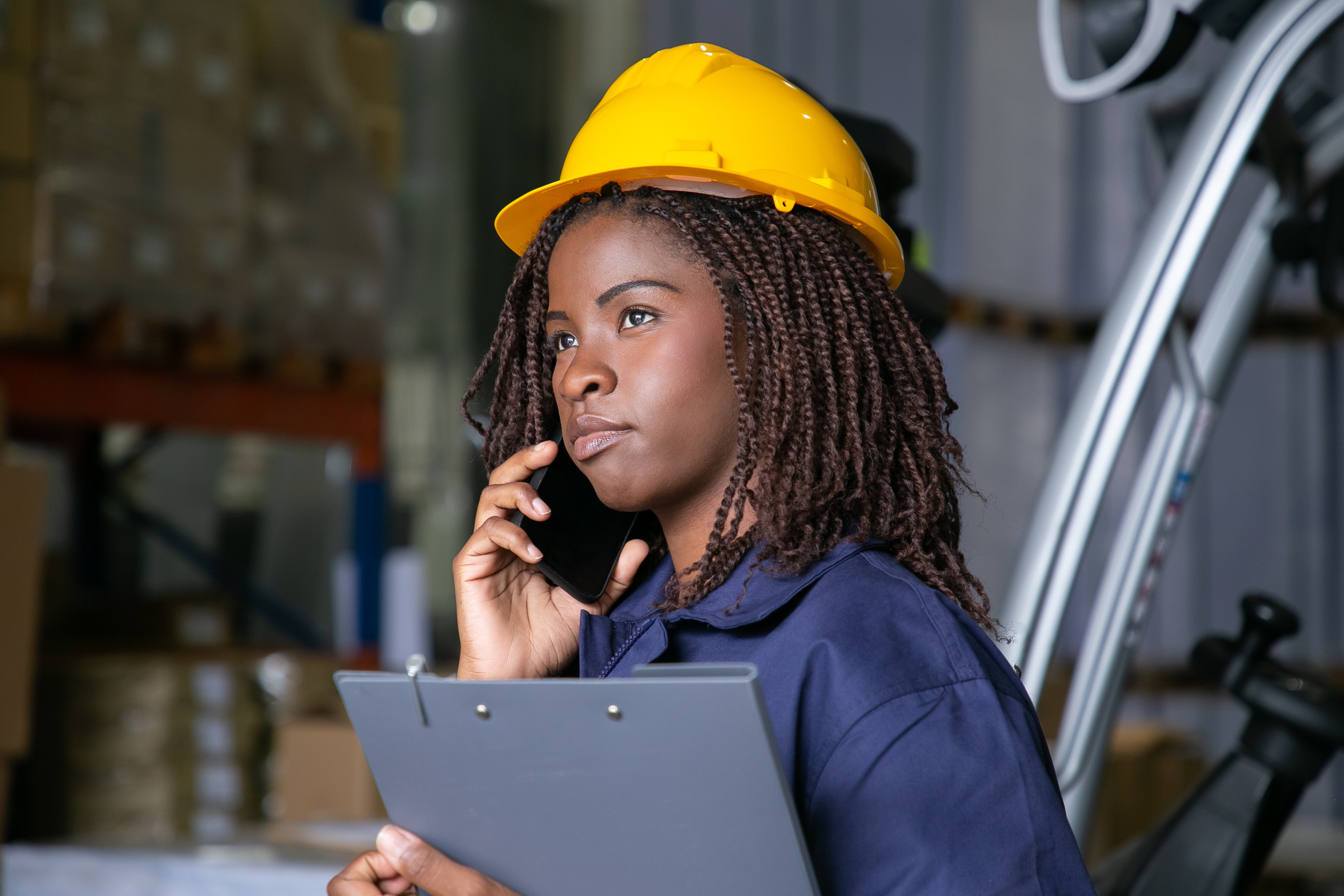 Pensive Black female engineer in hardhat
