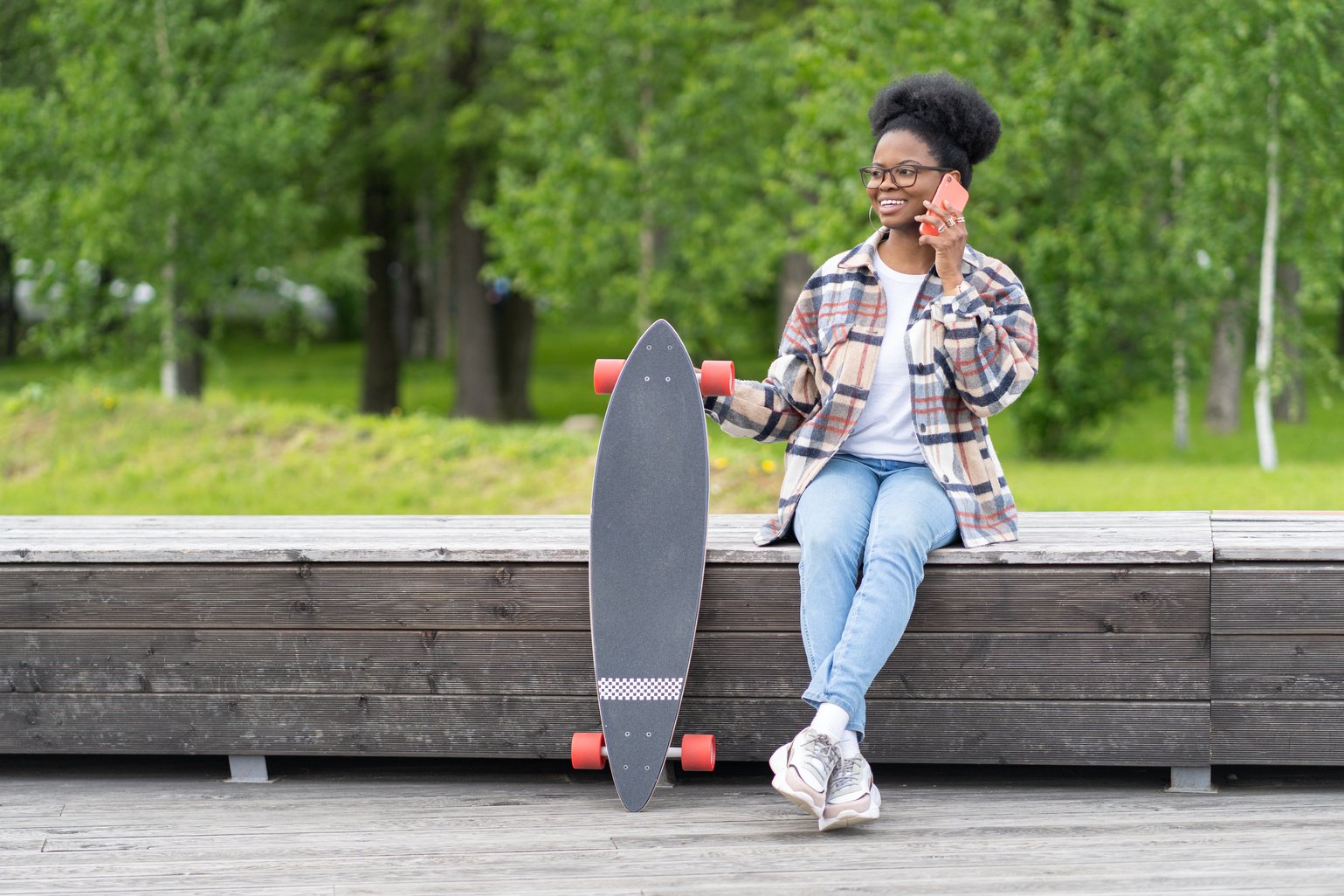 Female Skateboarder Taking a Call on the Street