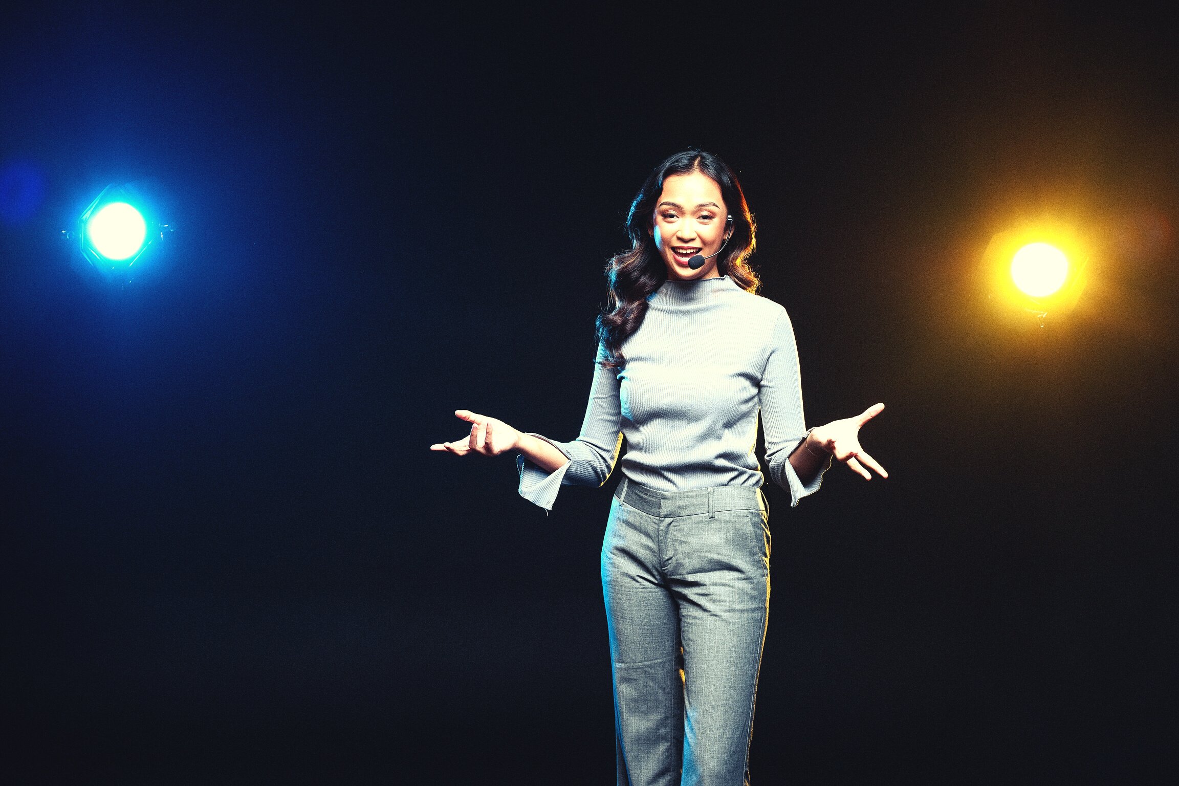 Woman Giving a Talk in Public on Stage