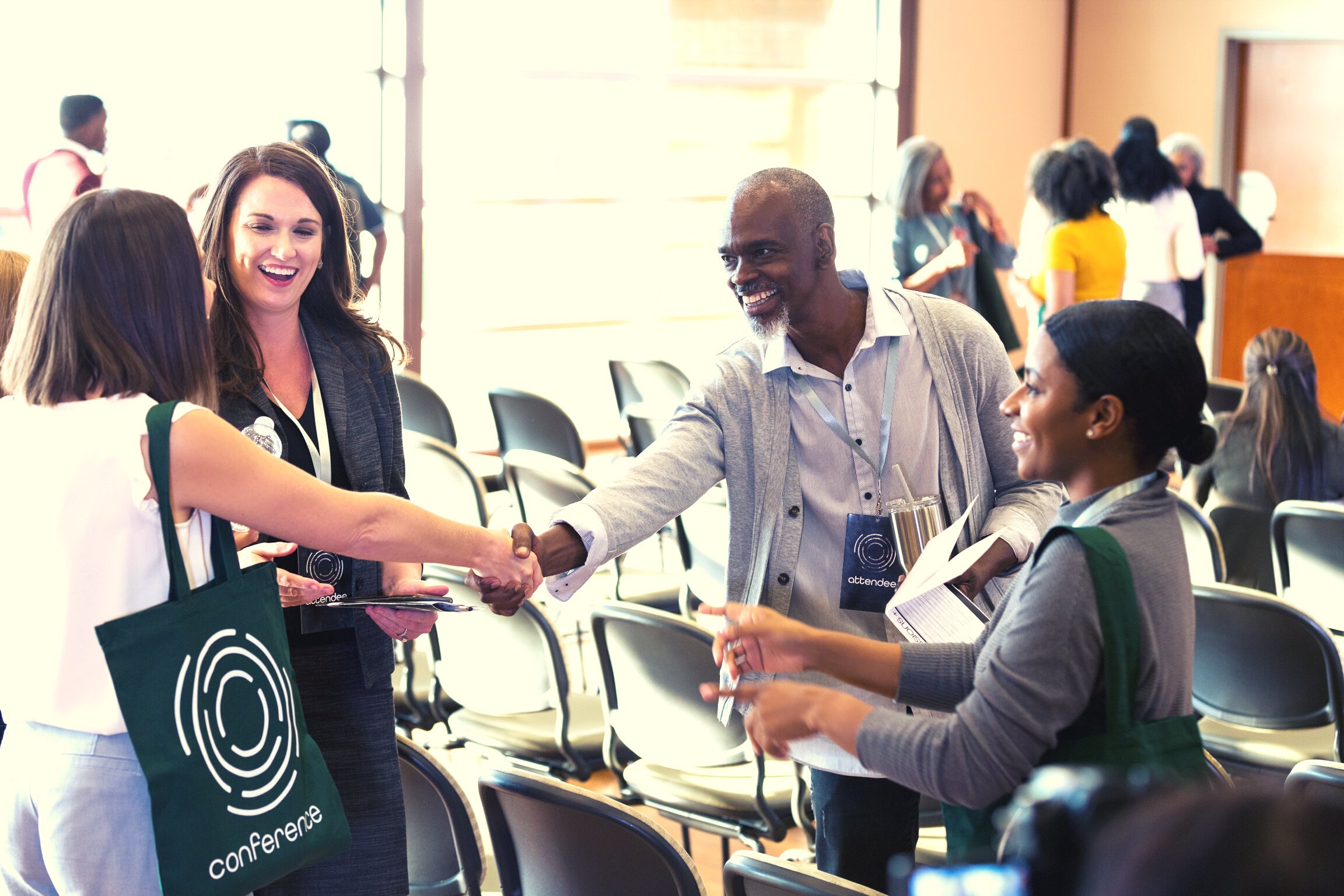 Business people greet one another at conference